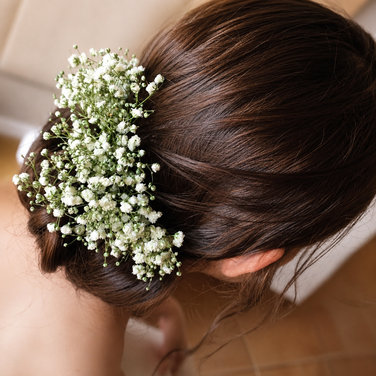 Brunette bridal updo finished with delicate baby's breath