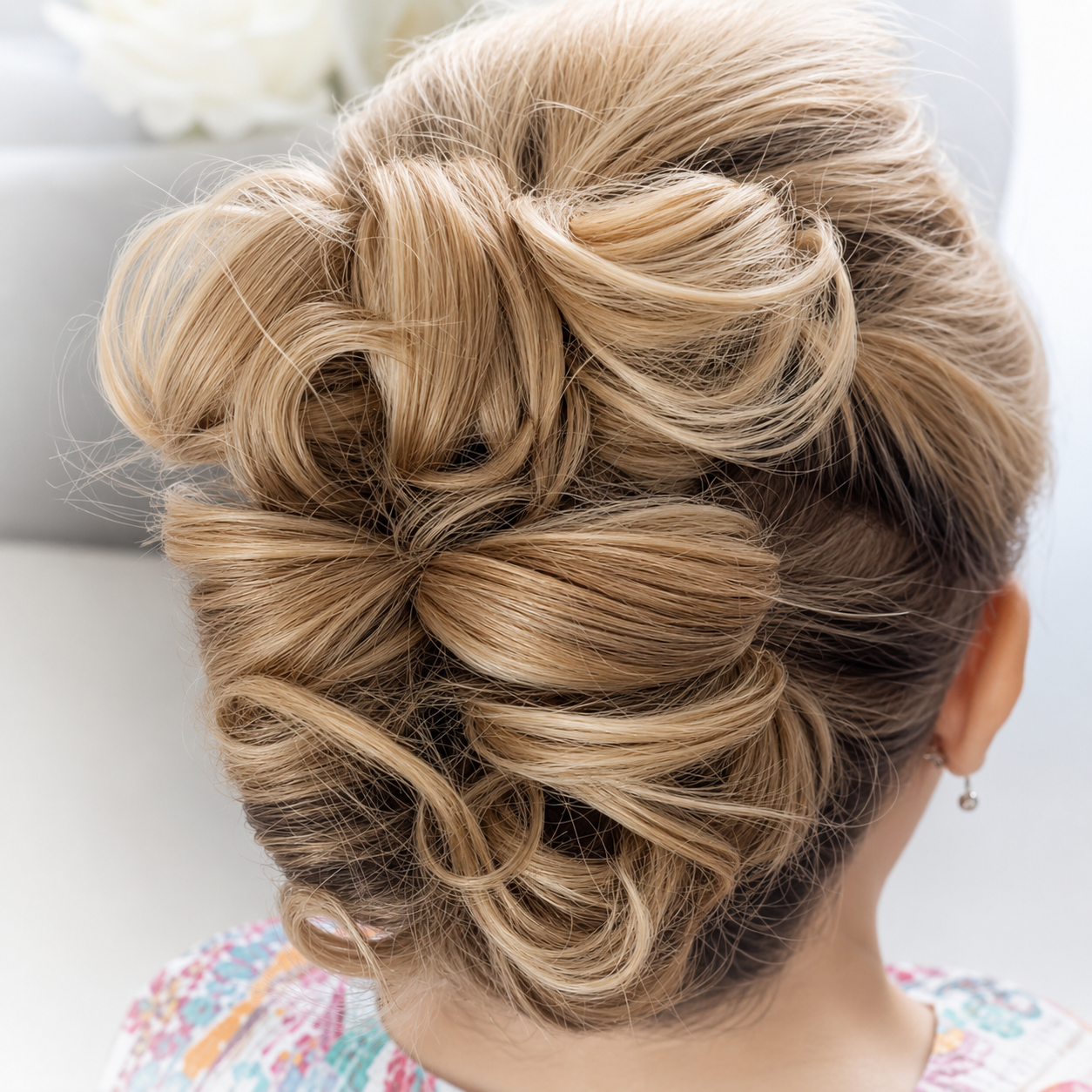 Intricate blonde bridal updo with softly sculpted detail
